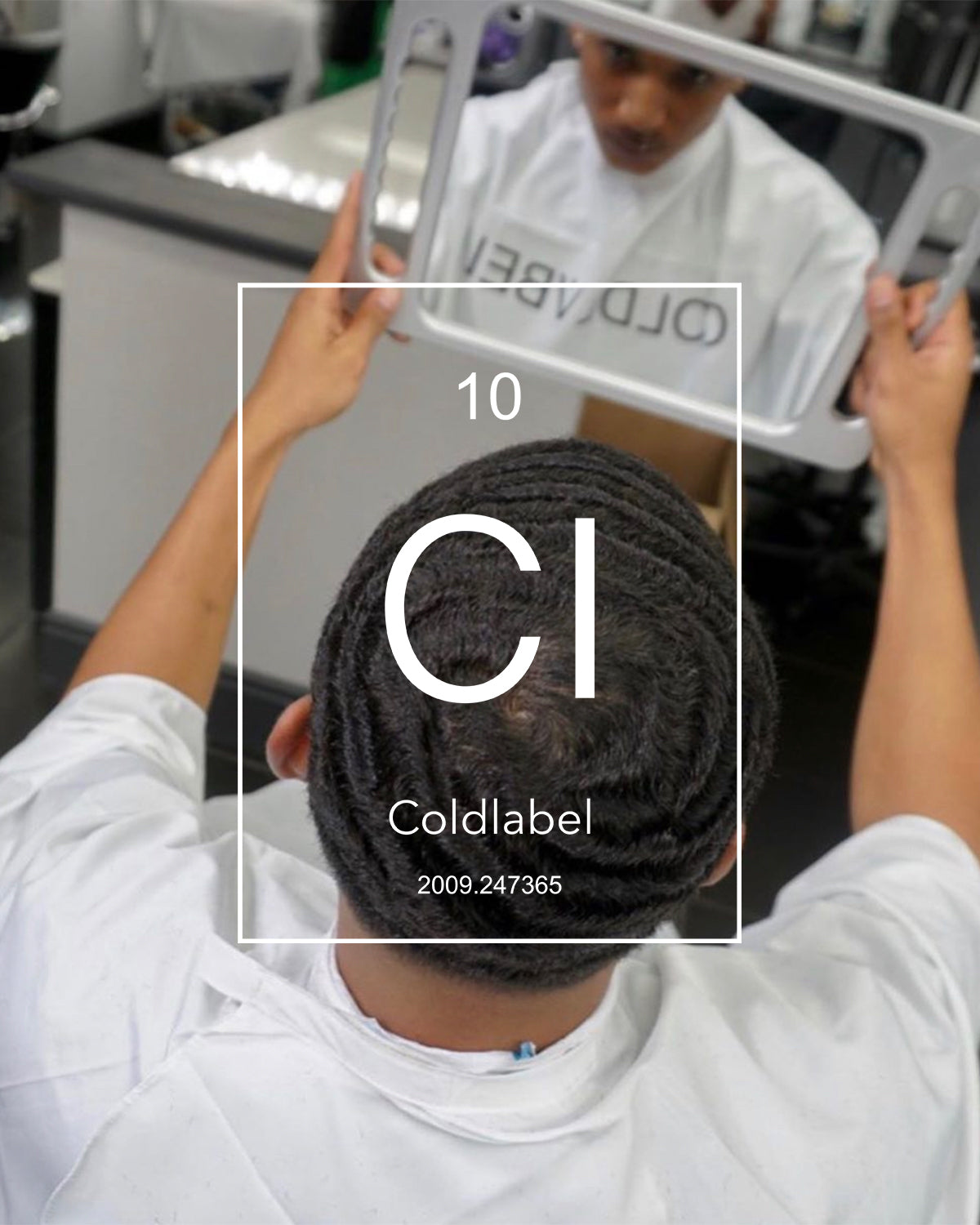 Male in barber chair holding mirror